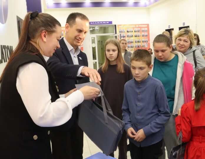 Владимир Рябцун вручает школьникам канцелярские наборы